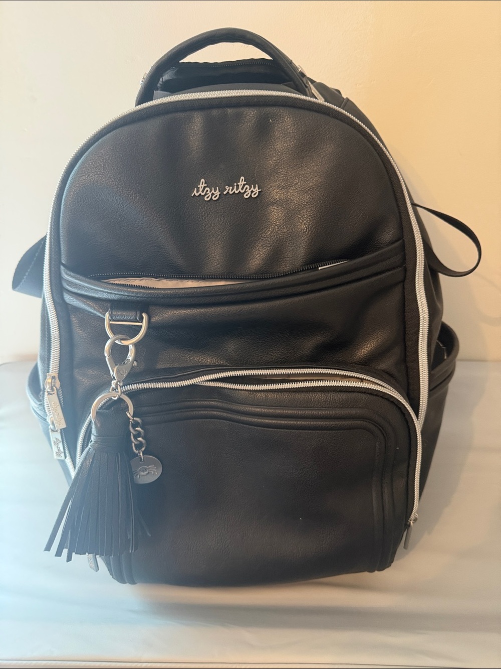 Itzy Ritzy Black Faux Leather Diaper Bag Backpack with Tassel Charm